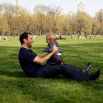 Man holding baby in the park