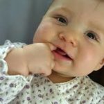 closeup of baby with finger in mouth