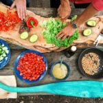 chopping vegetables on rustic board outdoors