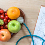 heart shaped bowl of fruit with stethoscope and chart