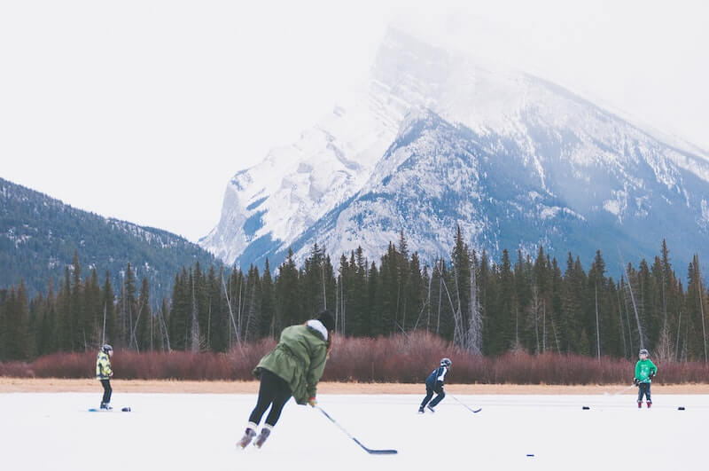Teenagers playing hockey on the pond