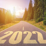 windy road with '2022' painted in yello