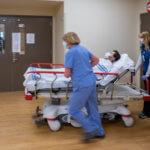 Rushing a man in gurney through the halls