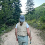 Nurse off duty going walking with fishing rod