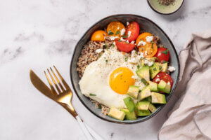 Plate with quinoa, avocado, egg and tomatoes. - Healthy Breakfast Ideas for Fall