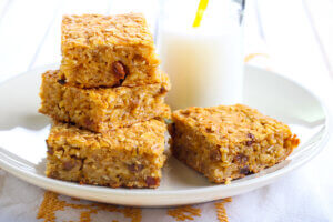 Pumpkin and oat bars with raisin and bottle of milk, selective focus - Healthy Breakfast Ideas for Fall
