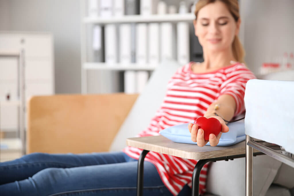 Woman donating blood in hospital - Benefits of Donating Blood
