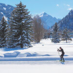 a man cross country skiing in aspen in winter for flurries of fun featured image