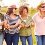Group Of Mature Female Friends Walking Along Path caring for women’s hormones